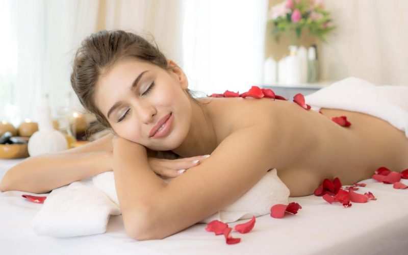 beautiful and healthy woman enjoying during a back massage in spa salon